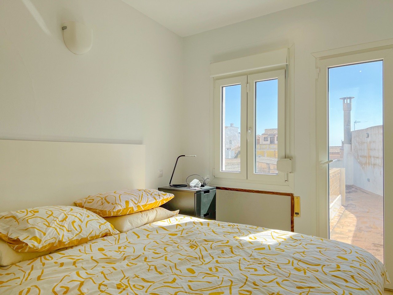 Rooftop terrace lit up at dusk with mountain and church views in house for sale Felanitx